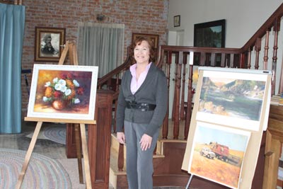 Deb Hendrickson posing with Charlotte Schacher Paintings